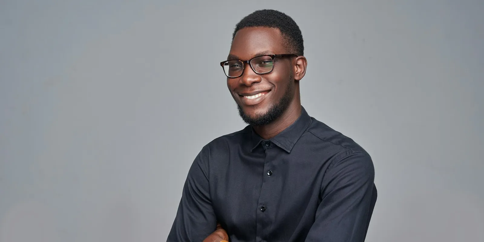 A business owner in glasses and a dark shirt